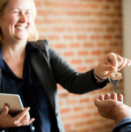 An estate agent handing over keys