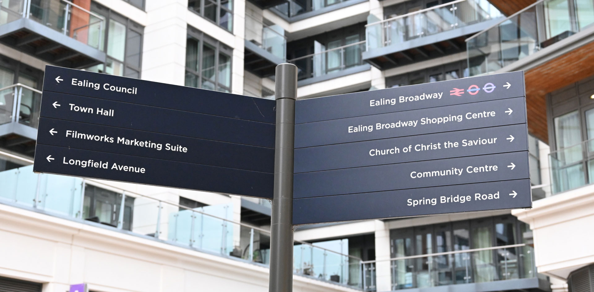 A lamp post with directions on it in Central Ealing